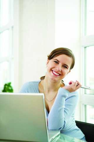Woman smiling in front of laptop